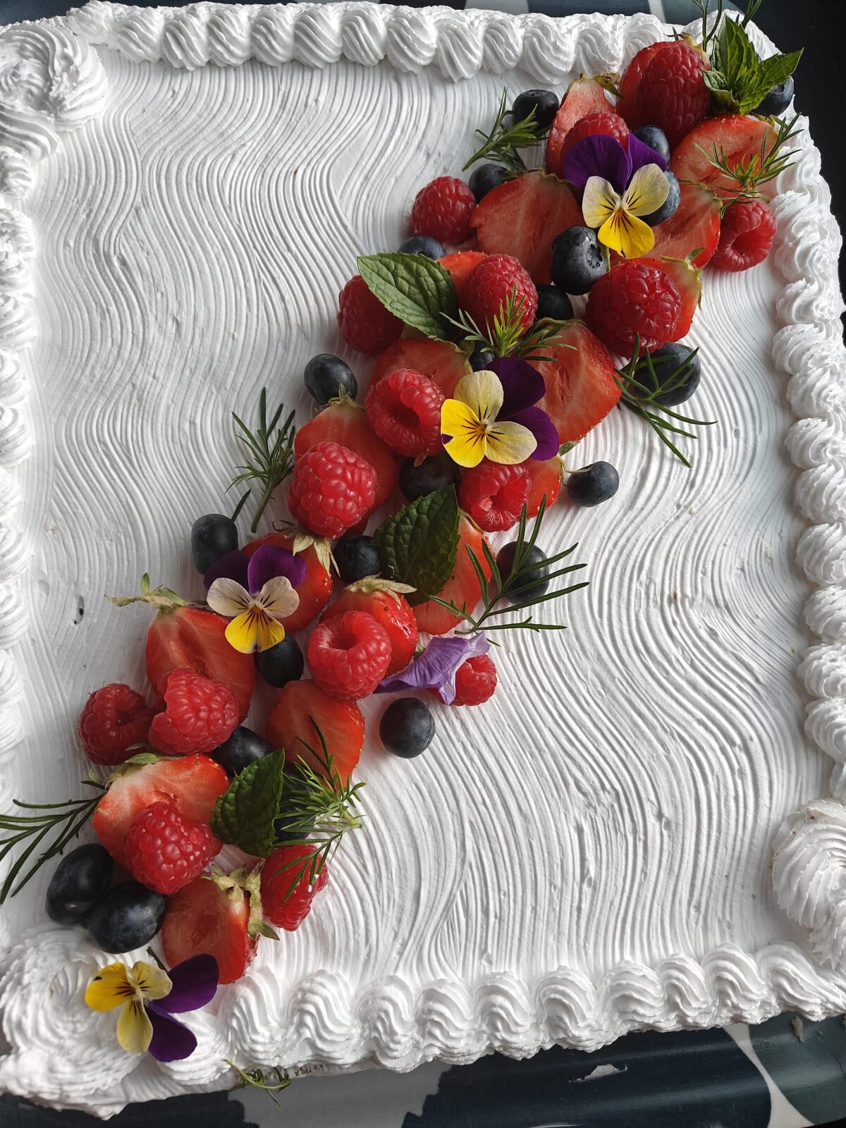 Berry cake decorated with chocolate and flowers